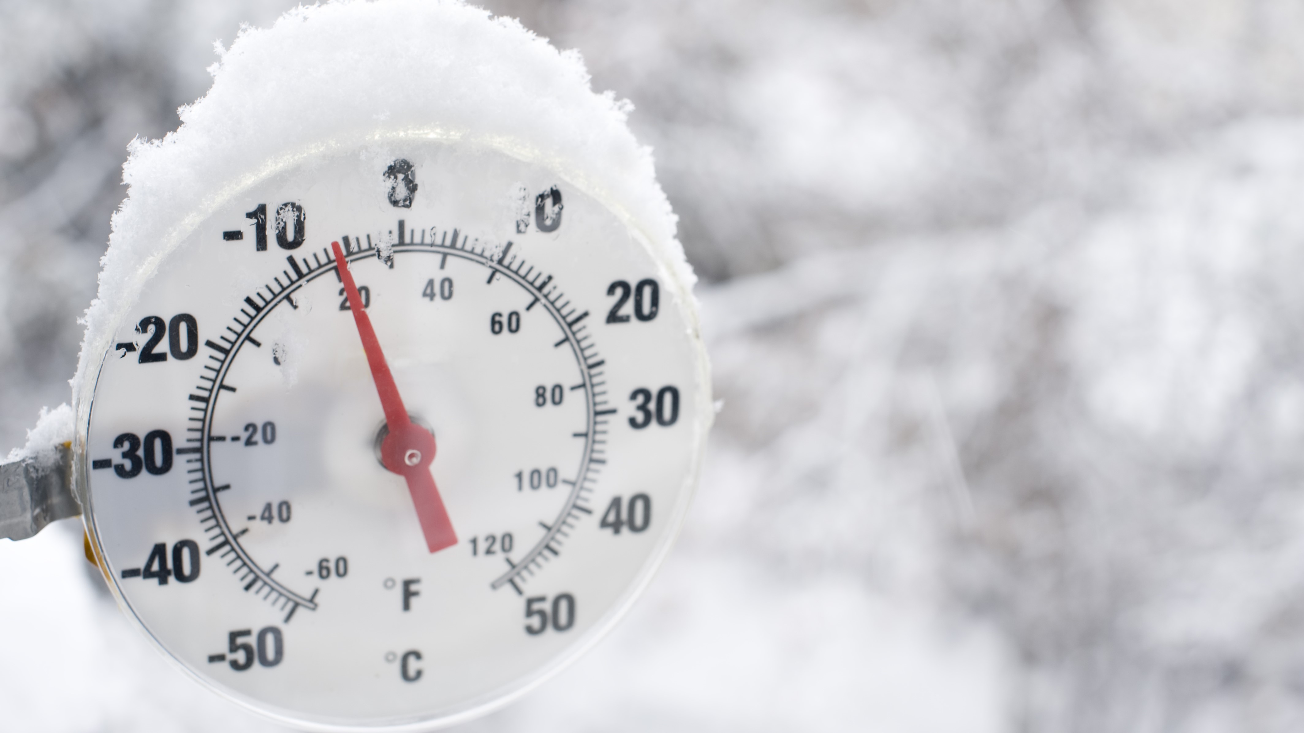 picture of thermometer in cold snowy weather, outside