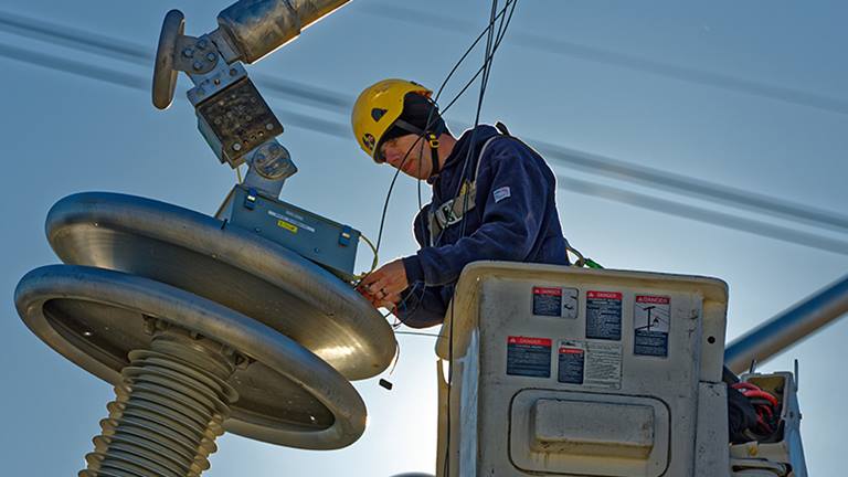 image of man working in a bucket on high-voltage electricity