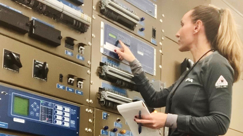 image of woman operating wall of technical equipment