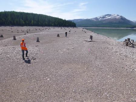 Archaeological pedestrian survey being conducted at Hungry Horse Reservoir, Hungry Horse Dam Project picture of people on shore