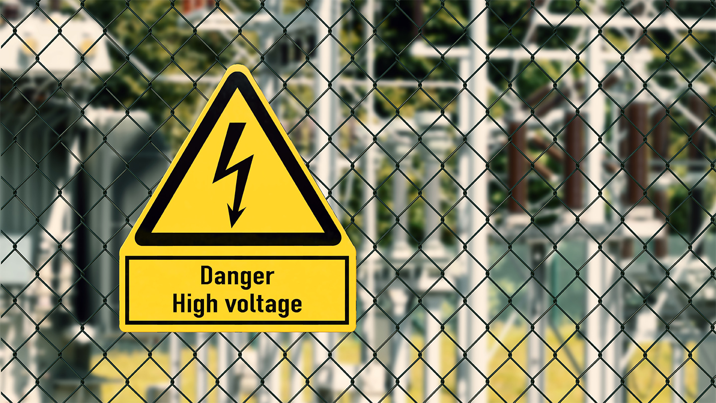 Danger High Voltage sign on a fence of a substation.