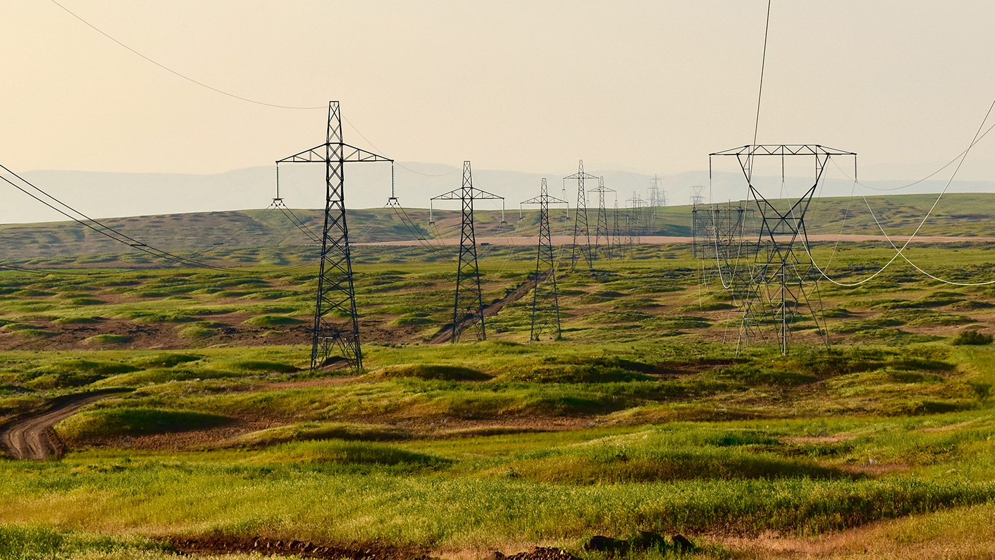 picture of transmission lines in green open plains