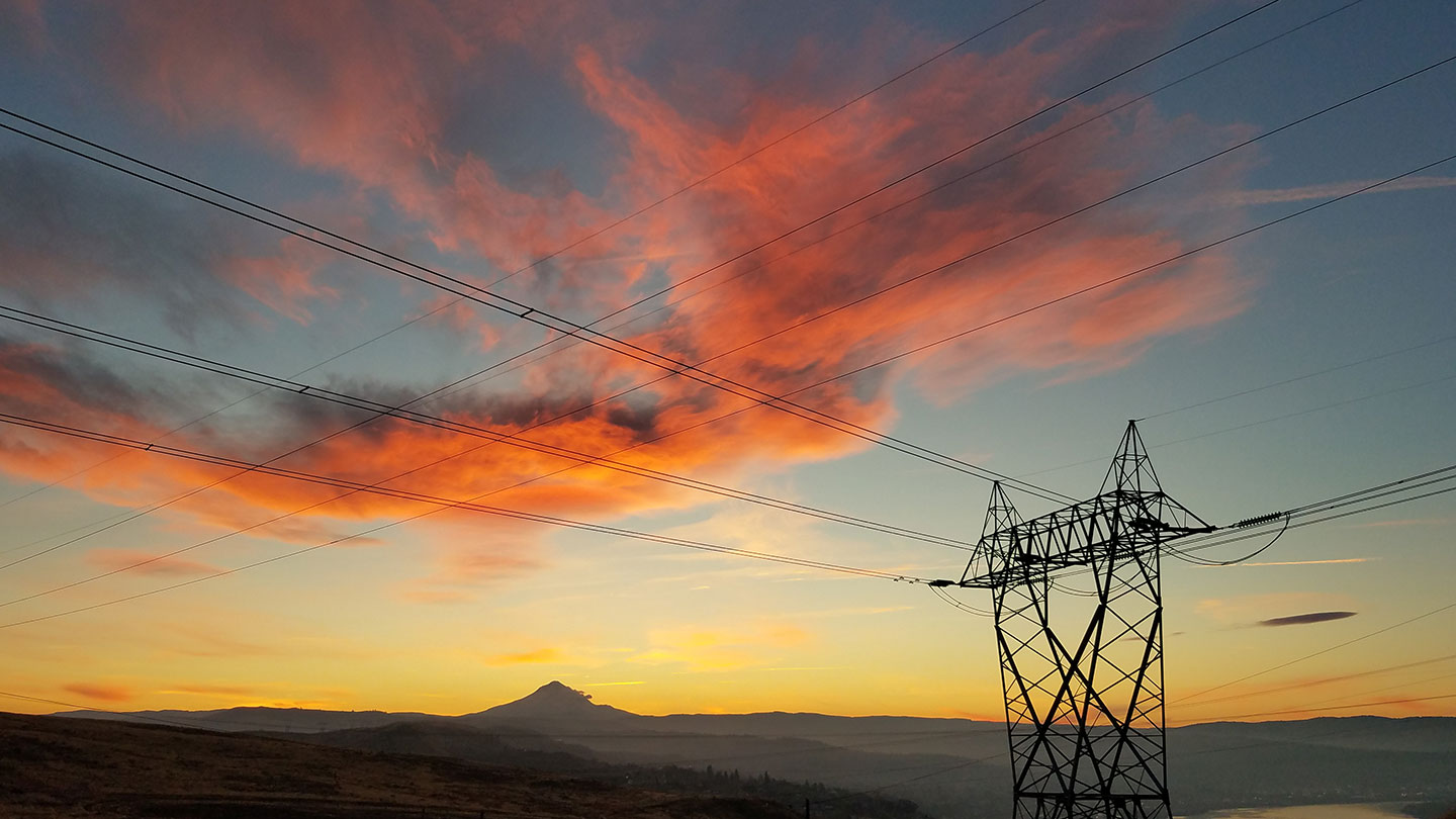 Capturing the day's last light, with the sun setting behind Mount Hood and the colorful sky reflecting off  the Columbia River near The Dalles, Oregon. 