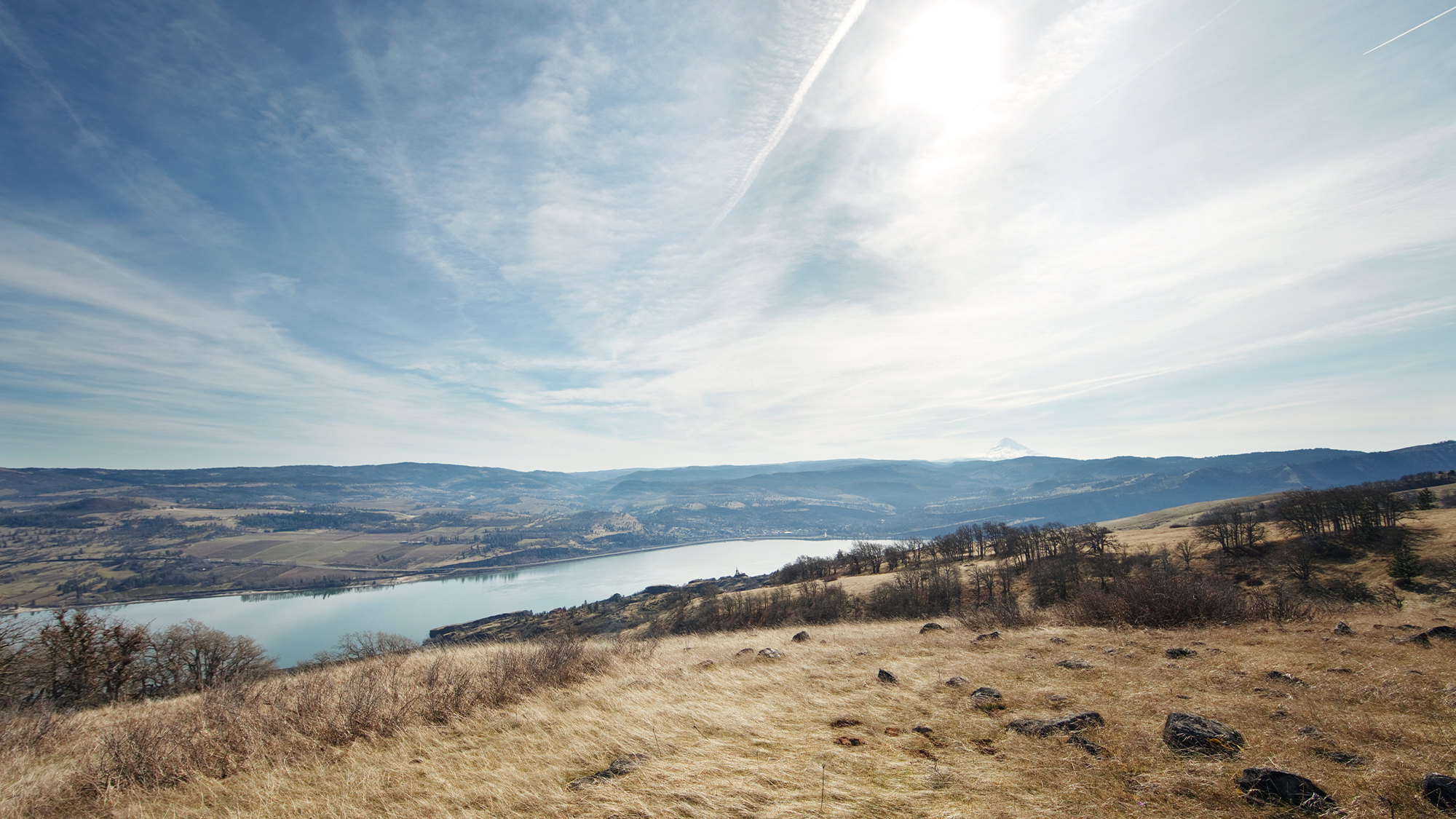 View from hill overlooking a river under the bright winter sun